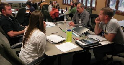 DNR foresters Mike Lichter (far right) and Scott Burns (second from right) discuss adaptation ideas with co-workers at a workshop. 