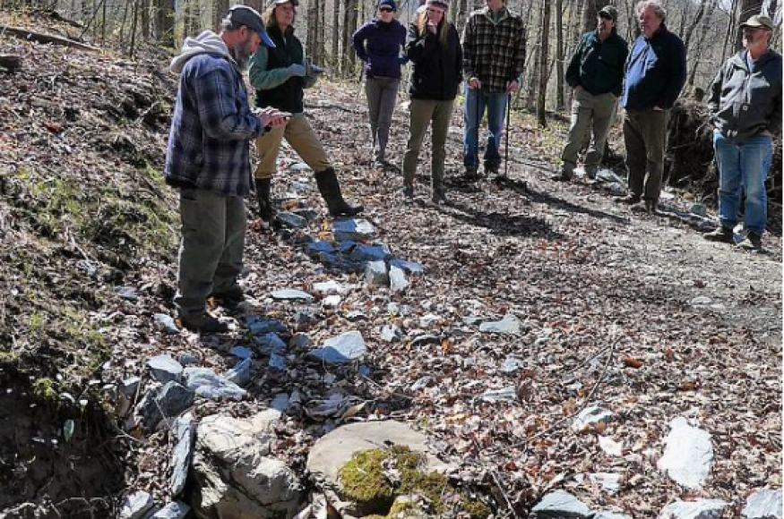 Group of woodlot program participants gathered in the forest on an early spring day