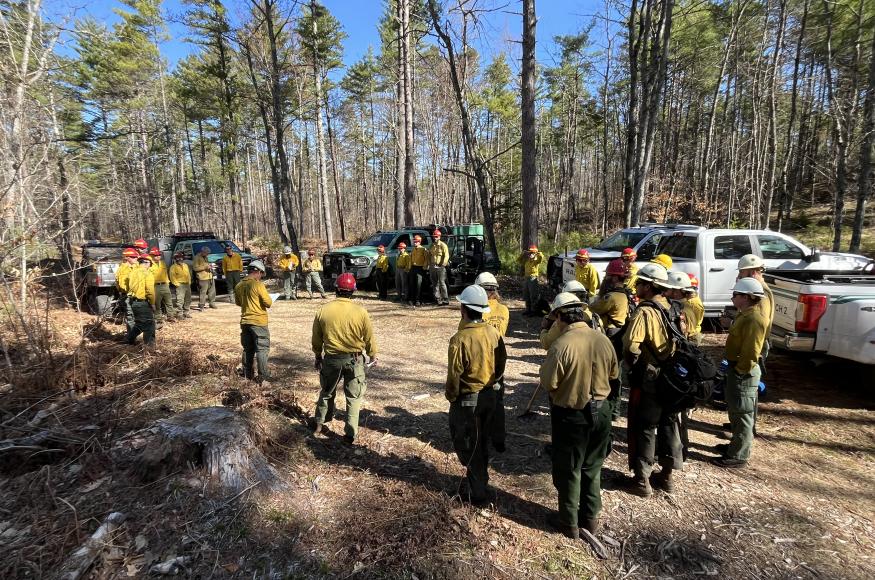 A group of foresters in wildland fire gear gathering