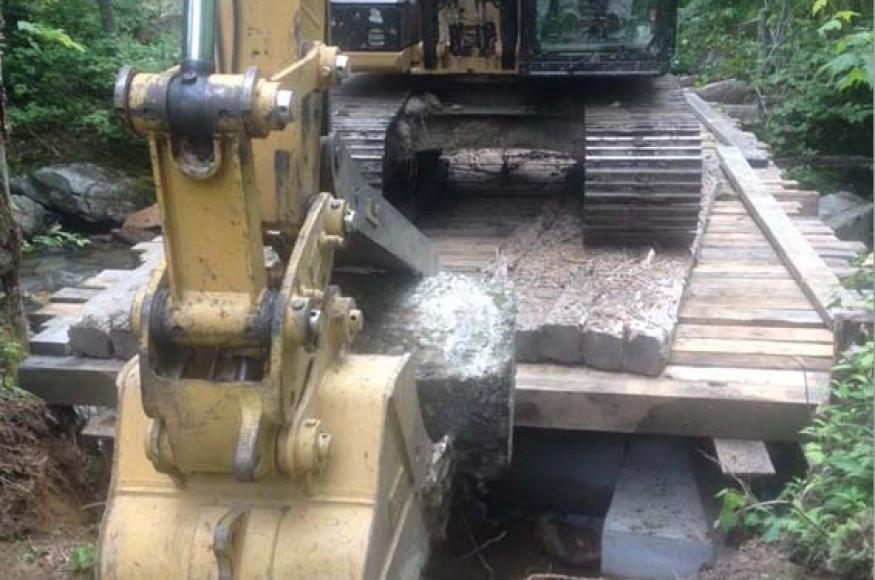 An excavator on a temporary bridge